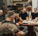 Men gathered in conversation in the men's shed at Sunshine Uniting Churxh